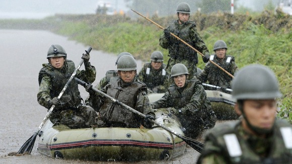 Japan Self-Defence Force soldiers search for missing people at an area hit by landslides caused by heavy rains in Aso, Kumamoto prefecture.