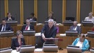 Carwyn Jones answering questions from party leaders.