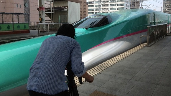 Meridian cameraman Naoya Issa films a bullet train in Japan