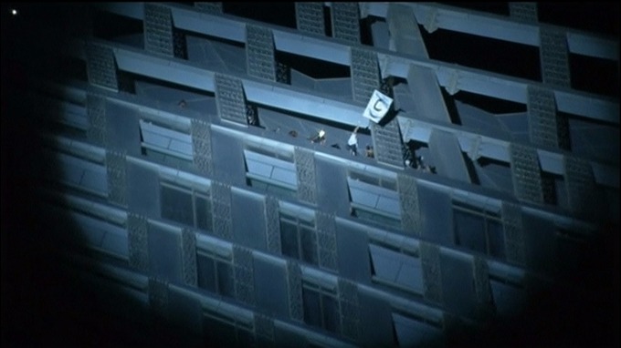 Alain Robert at the top of the Cayan Tower