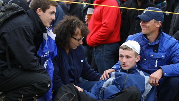 Jason Blue, aged 16, from Bristol with a bandaged head after a stray ball from Northern Ireland's Rory McIlroy hit him on the head.