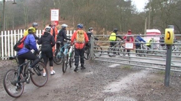 Cyclists at the Moors Gorse level crossing near Hednesford in Staffordshire