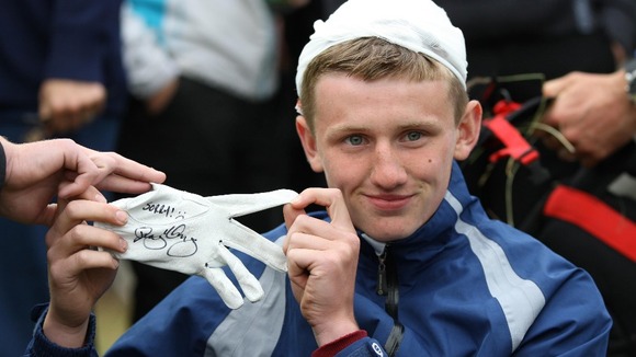 Jason holds up the glove McIlroy signed for him.