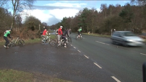 Cyclists crossing the A460 near Cannock Chase