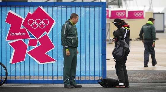A G4S employed security guard checks an athlete's accreditation 