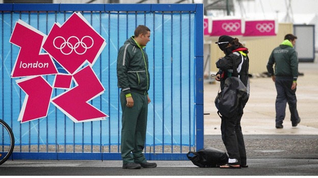 A G4S employed security guard checks an athlete's accreditation