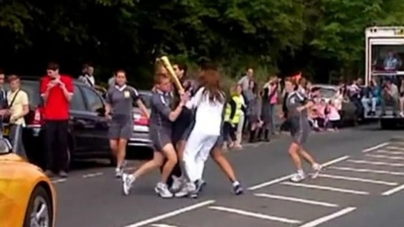 Security guards surround the Olympic Torch