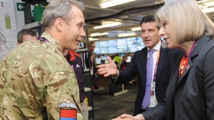 Theresa May meets Colonel Gary Wilkinson as she views the Olympics security control room in the Olympic park