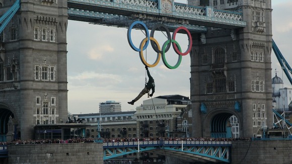 Royal Marine Martin Williams abseiling from a helicopter with the Olympic flame into the grounds of the Tower of London