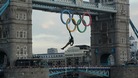 Royal Marine Martin Williams abseiling from a helicopter with the Olympic flame into the grounds of the Tower of London