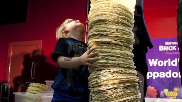 Mia Mason aged 4 helps the chefs of Poppadom Restaurant attempt to break the Guinness World Record
