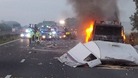 The lorry on fire after the collision between the lorry and a car towing the caravan on the M6
