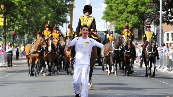 Jaco-Albert Van Gass carrying the Olympic Flame on the Torch Relay leg through Greenwich.