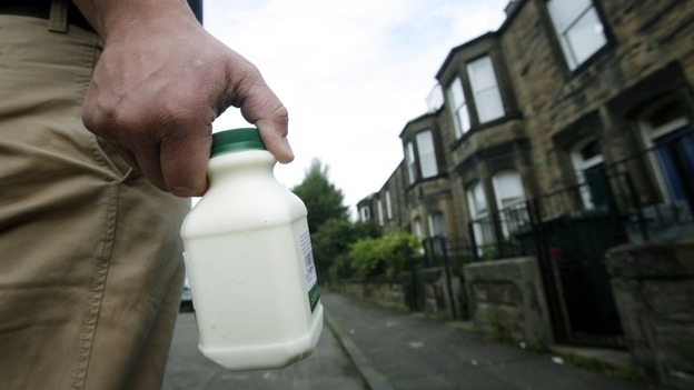 Man delivers a carton of milk