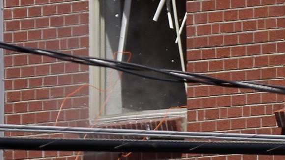 A small amount of smoke is seen at a window of Holmes' apartment in Aurora