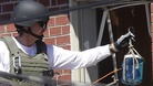 Officers put a container filled with blue liquid to use in the explosion 