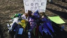 A sign is seen outside a vigil for victims behind the theater where a gunman opened fire on moviegoers