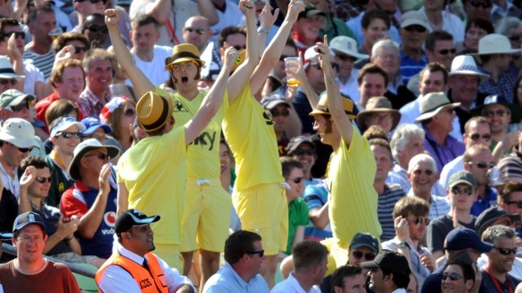 Fans dressed as Bradley Wiggins celebrate as the cyclist became the first British rider to win the Tour de France