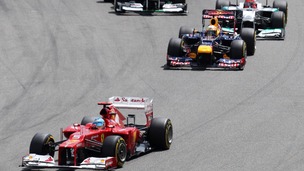 Ferrari's Fernando Alonso, left, leads Red Bull driver Sebastian Vettel, center after the start of the German F1 Grand Prix