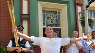 Eastenders character Billy Mitchell played by Perry Fenwick carries the Olympic torch