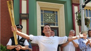 Eastenders character Billy Mitchell played by Perry Fenwick carries the Olympic torch
