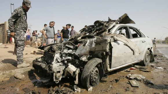 A policeman stands guard at the site of a bomb attack in Kirkuk, 250km (155 miles) north of Baghdad