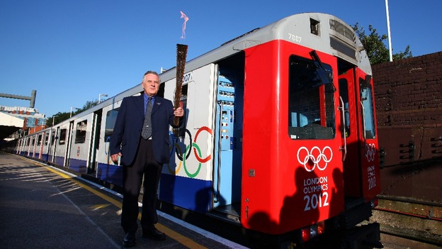 London Underground employee John Light and the Olympic flame