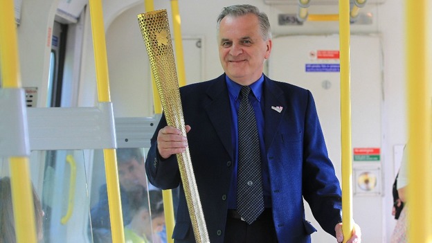 London Underground employee John Light and the Olympic flame