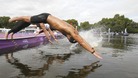A marathon swimmer dives into the Serpentine lake in Hyde Park.