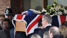 Pallbearers carrying the coffin of PC David Rathband into Stafford Crematorium