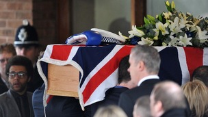 Pallbearers carrying the coffin of PC David Rathband into Stafford Crematorium
