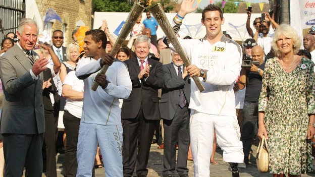 Duchess of Cornwall and the Prince of Wales with Torchbearers 127 Jay Kamiraz and 129 Scott Moorhouse