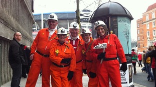 Fans dressed as miners