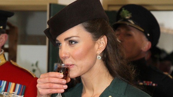 The Duchess of Cambridge holds a glass of Harvey's Bristol Creme in the Junior's Mess as she visits Aldershot Barracks.