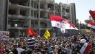 People gather at the site of the bomb attacks in Damascus today.