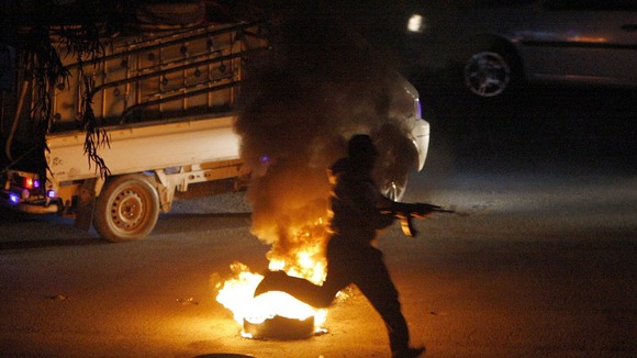 A armed anti-government protester in the suburbs of Damascus last night.