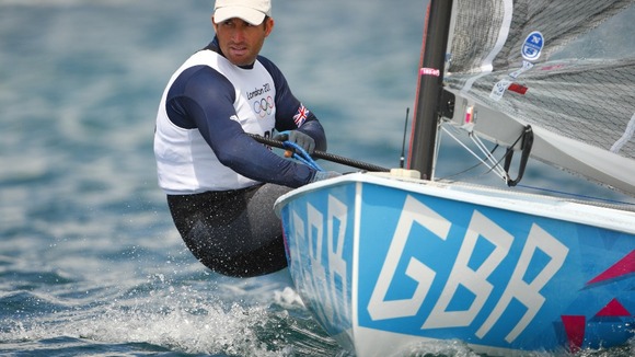 Ben Ainslie practices in his Finn dinghy on Weymouth Bay
