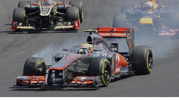 Lewis Hamilton breaks while leading the race after the start of the Hungarian Formula One Grand Prix