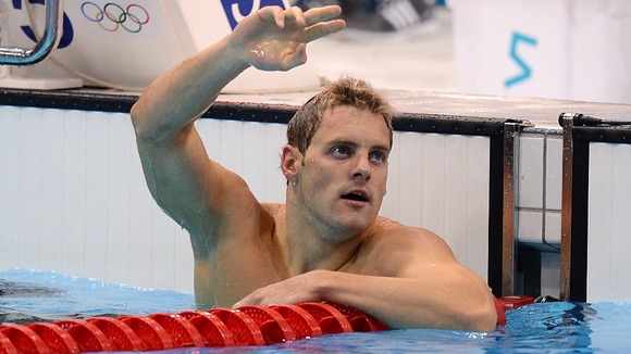 Liam Tancock celebrates after finishing second in his Men's 100m Backstroke Heat at the Aquatics Centre on the second day of Olympics.