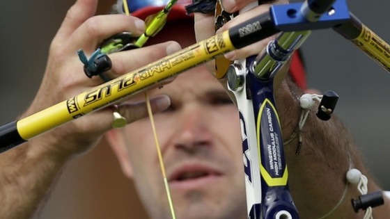 Alan Wills prepares to shoot during the elimination stage at the 2012 Summer Olympics, Saturday