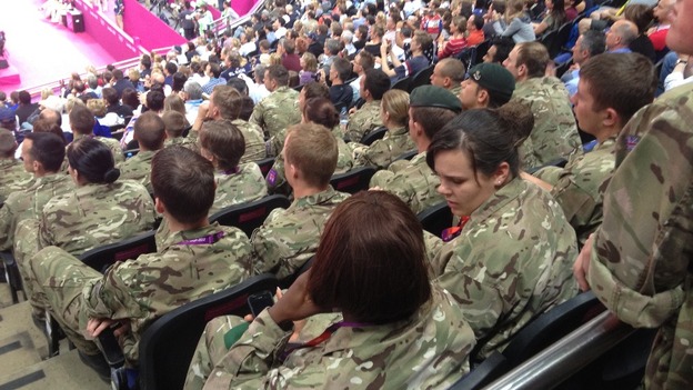 After: Empty seats at the men's gymnastics final filled by military personnel