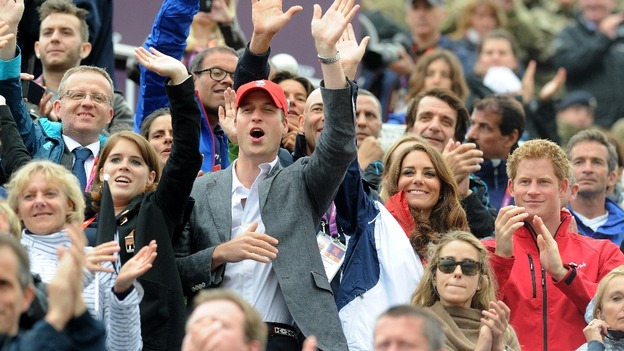 The Duke and Duchess of Cambridge cheer and wave as Great Britain's Eventing team arrive to collect their medals