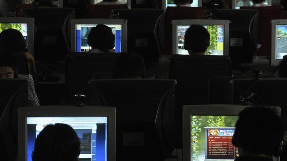 Lots of people inside a computer room.