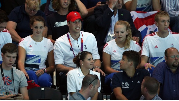 Prince William sits amongst the spectators as he watches Great Britain play Serbia during their Group B preliminary water polo match