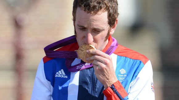 Bradley Wiggins kisses his gold medal after winning the men's cycling individual time trial