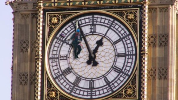 Hanging from the clock face on the tower that houses Big Ben.