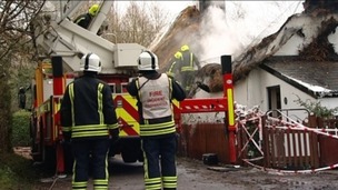 Fire service at scene of thatched cottage fire