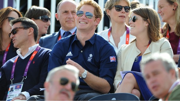 Prince Harry shares a joke with Princess Eugenie as they watch the Olympic Eventing