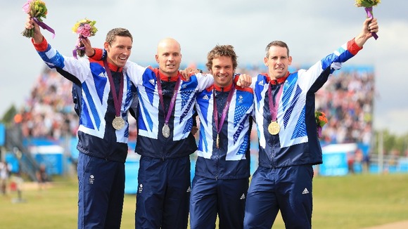 GB's David Florence and Richard Hounslow with their silver medals celebrate with Tim Baille and Elienne Stott with their gold medals.