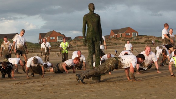 Participants completing press-ups on Crosby beach